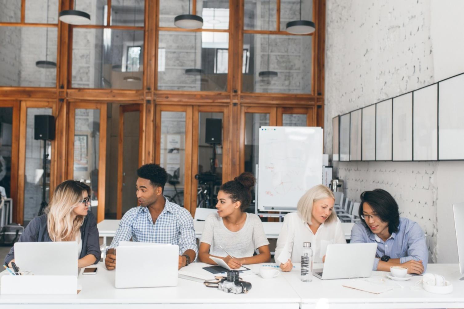 Economic planning workspace with financial documents and analysis tools